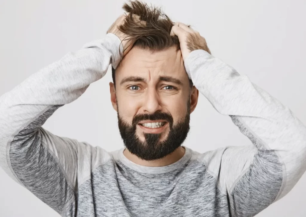 troubled bearded guy panic tossing hair look scared
